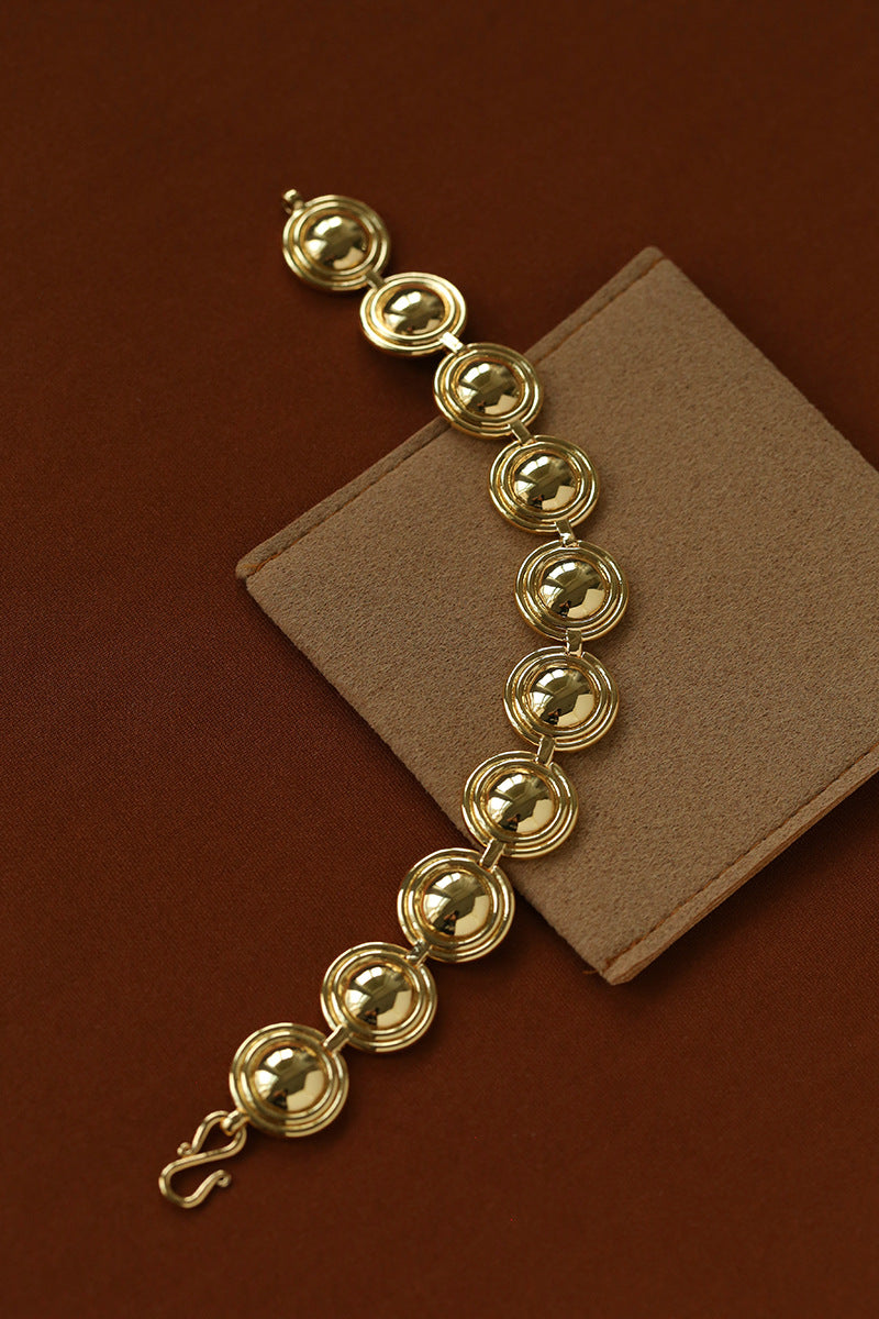 Gold oval dome link bracelet laid flat