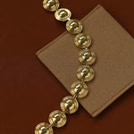 Gold oval dome link bracelet laid flat