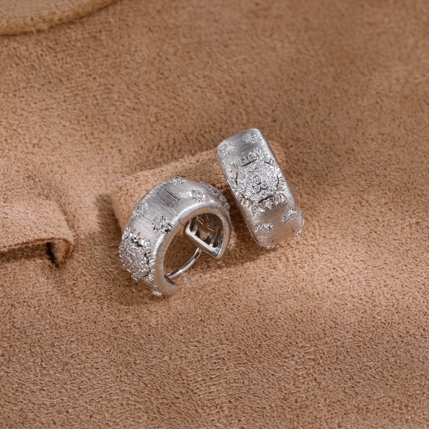 Silver floral cubic zirconia hoop earrings - styled pair view