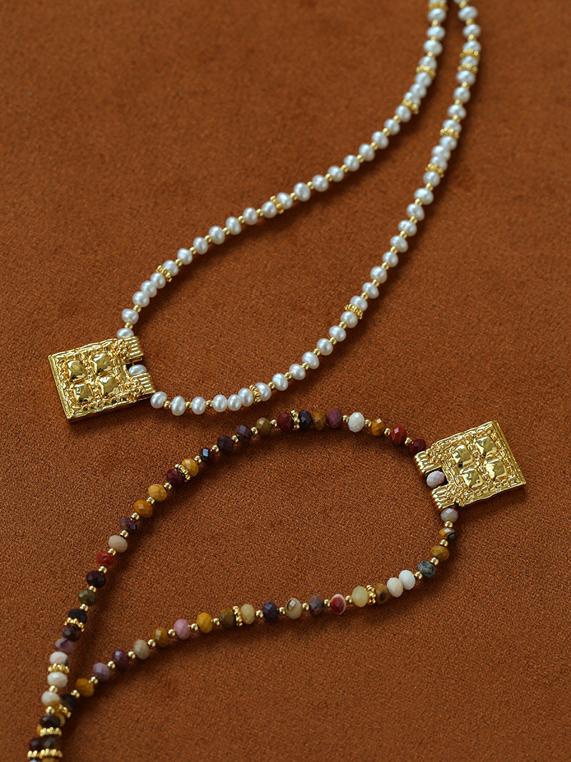 Pearl and natural stone necklace styles on a brown background