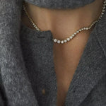 Gold graduated CZ necklace styled with a grey cardigan