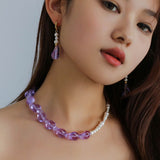 Short pearl hoop purple glass earrings styled on a model