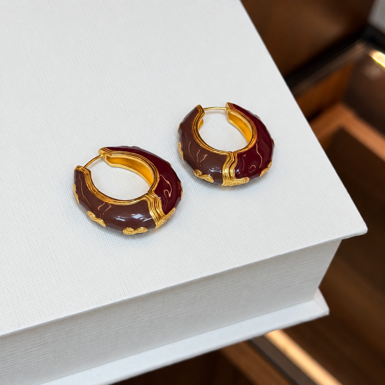 Vintage burgundy enamel sculpted hoop earrings - front pair view
