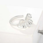 Silver sculptural ruffle ring on a white display