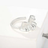 Silver sculptural ruffle ring on a white display