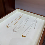 Three finishes of ruffle necklaces in a jewellery tray