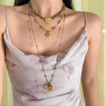 Labradorite and garnet necklace styled with a light dress