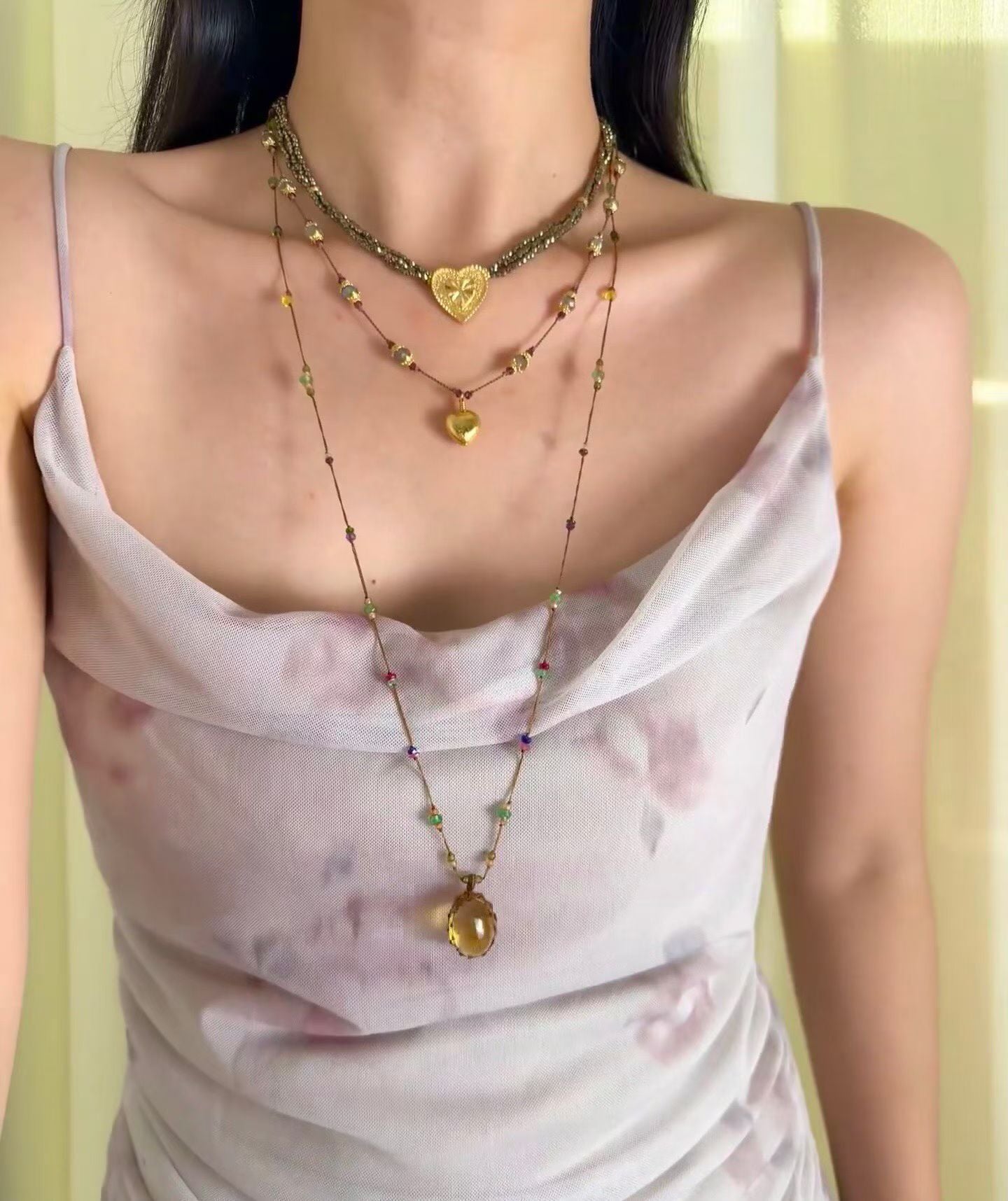 Labradorite and garnet necklace styled with a light dress