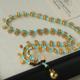 Mini Faceted Turquoise Bead Necklace with Gold Flower Pendant - floysun