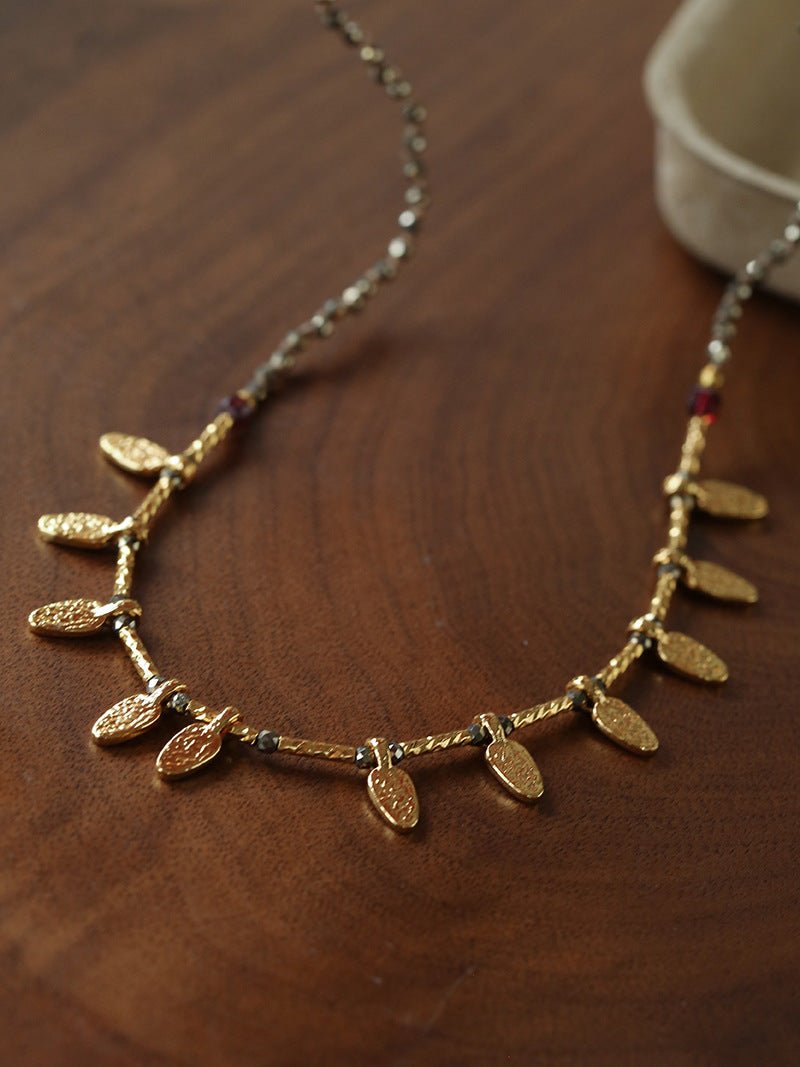 Vintage pyrite leaf charm necklace styled for everyday wear
