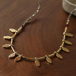 Vintage pyrite leaf charm necklace styled for everyday wear
