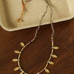 Hand-strung pyrite necklace with hammered gold leaf charms
