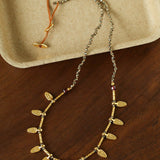 Hand-strung pyrite necklace with hammered gold leaf charms