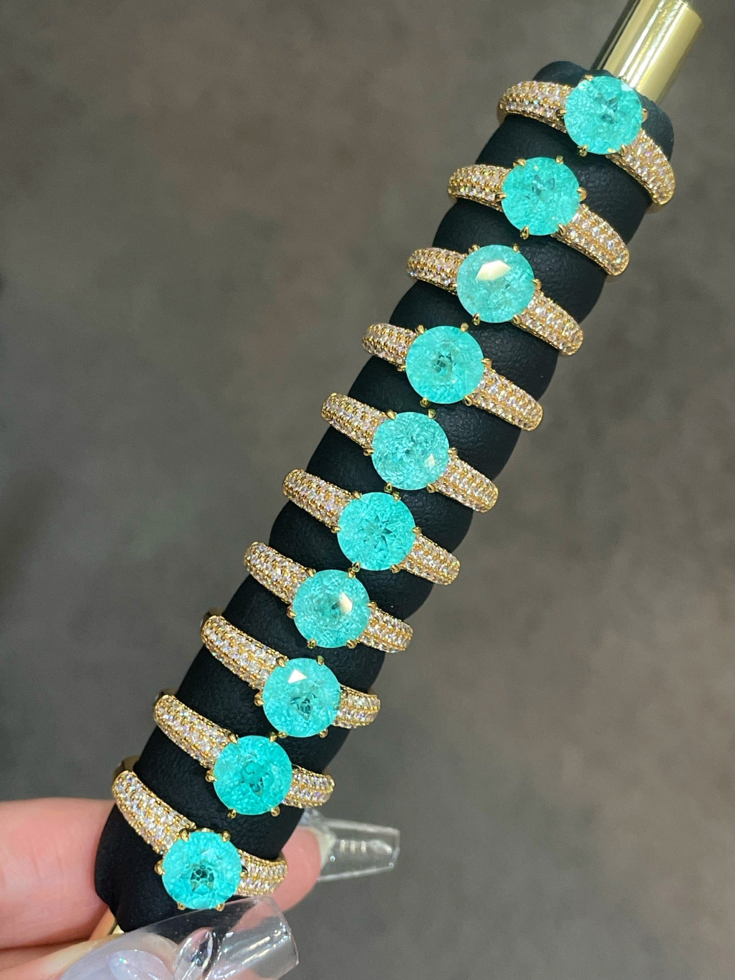 Blue-green round gemstone rings with pavé-set gold bands