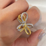 Sculptural gold and silver bow ring with sparkling simulants