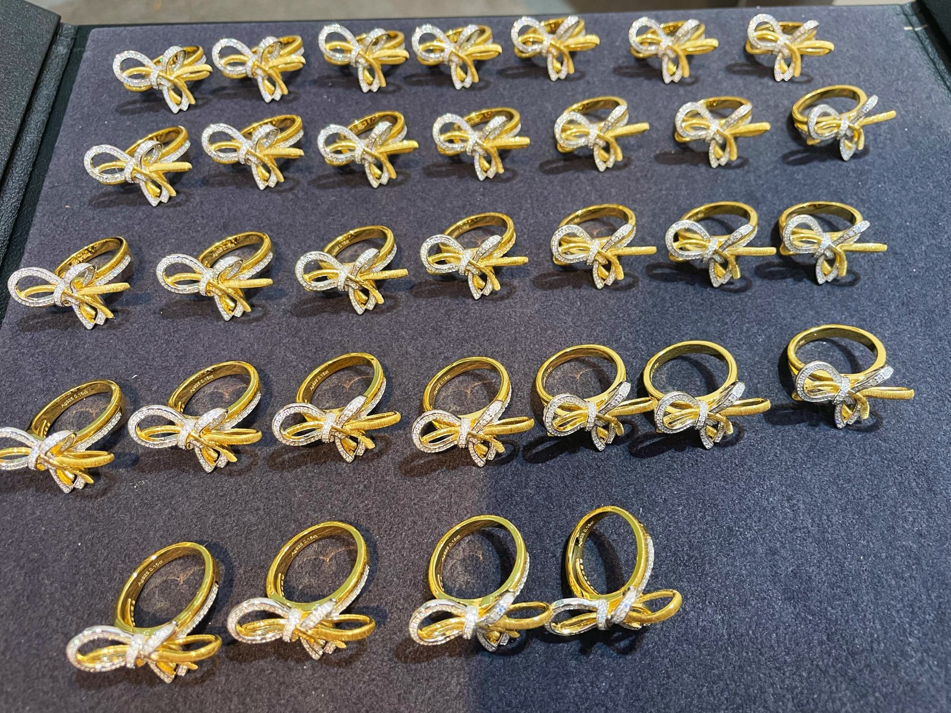 Collection of two-tone brushed bow statement rings