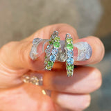 Close-up of hand-set multicolour diamond simulant hoops