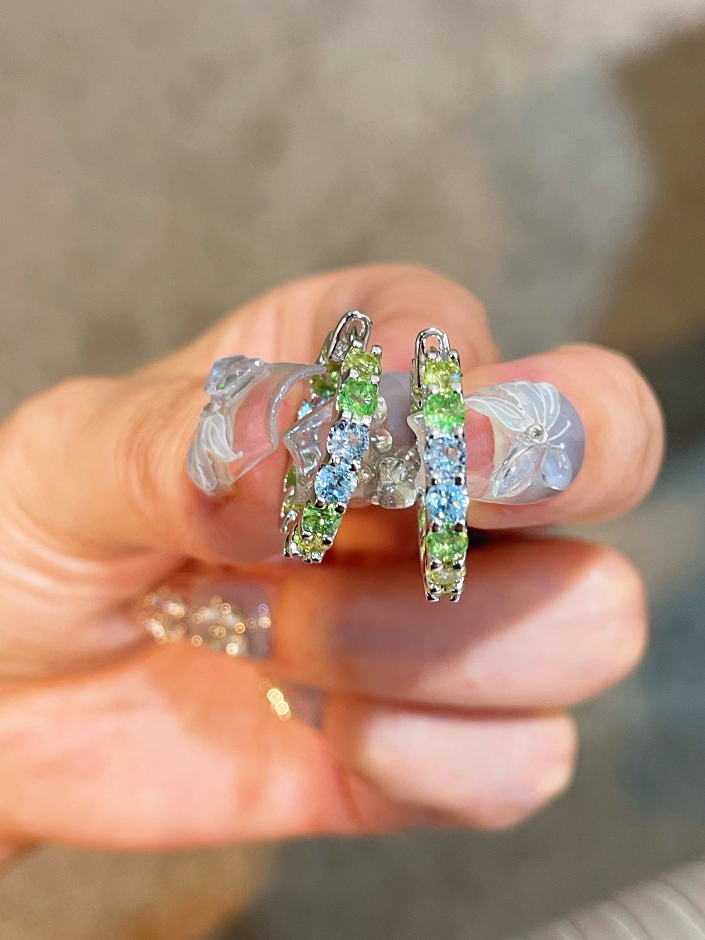 Close-up of hand-set multicolour diamond simulant hoops