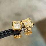 Close-up of clear rectangular stones in irregular gold frames