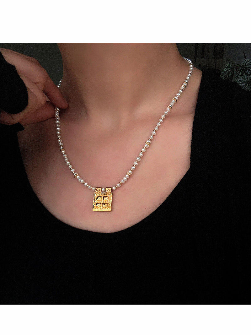 Freshwater pearl square pendant necklace worn at the neckline
